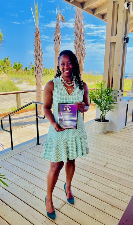 lady holding an award